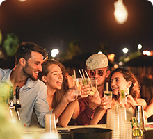 Friends enjoying drinks outside in the evening